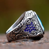 Close-up detail of the oxidized finish and engraved decorative patterns on the stainless steel ring band