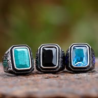 Top-down view highlighting the faceted black centerpiece stone secured in a raised steel bezel setting