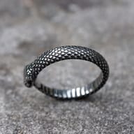 Textured scales visible on the body of the stainless steel snake ring.