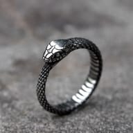 Close-up of the detailed snake head design on the stainless steel ring.