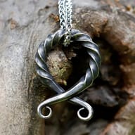Textured surface of the stainless steel Norse pendant showing highlights