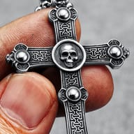Angle shot of the skull cross pendant showing intricate patterns and side studs