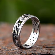 Close-up of the intricate interwoven Celtic knot design on the upper part of the ring