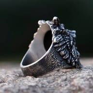 Side view of the stainless steel skull wolf head ring, showcasing the robust band and the three-dimensional sculpt.