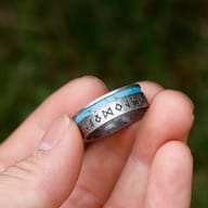 Top-down view of durable Norse rune band ring with synthetic turquoise accent