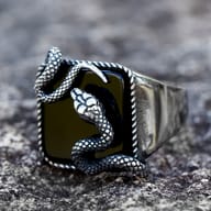 Close-up shot of the snake's body on the ring, revealing the intricate texture and dark oxidized finish on the scales.