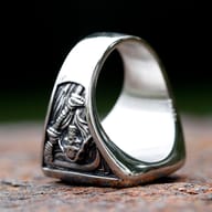 Side detail of the thick band and death sickle blade on the vintage stainless steel skull ring.