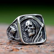 Front-angle close-up highlighting the intricate skull and cowl design on the men's stainless steel ring.