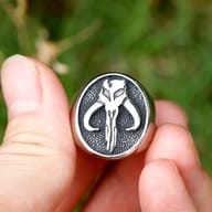 Stainless steel signet ring featuring the Mythosaur skull, shown from a slightly elevated perspective.