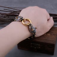 Viking wolf head bracelet worn on a man's wrist showing scale and fit