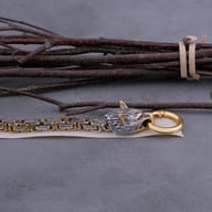 Side profile detailing the spring-ring closure and textured wolf head features