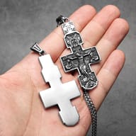Close-up of the top section of the Orthodox crucifix pendant, highlighting the bail and upper iconography.