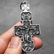 Detailed view of the center of the Orthodox crucifix pendant, focusing on the figure of Christ.