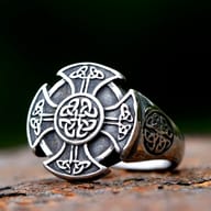 Side perspective displaying the solid construction and carved details of the ring