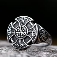 Angled profile showing the intricate knotwork band of the Celtic cross ring