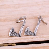 Close-up of the 316L stainless steel hoop closures of two Viking axe drop earrings, against a dark gray surface.