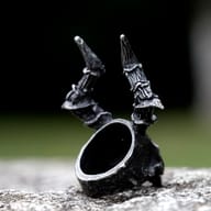 Angle view of the gothic skull ring on a dark background, emphasizing its textured surface and powerful design