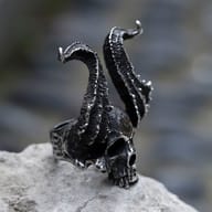 Horned skull steel ring worn on a hand showing scale and fit