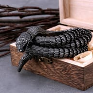 Close-up of the detailed snake head clasp on a stainless steel chain