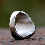 Top-down view highlighting the oval black zircon and ornate band