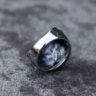 Detailed view of the ribbed band and skull moth feature of the men's stainless steel ring.