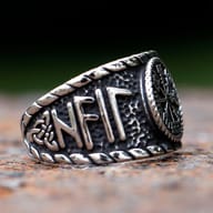 Side angle showing the carved Nordic runes and textured band of the steel ring