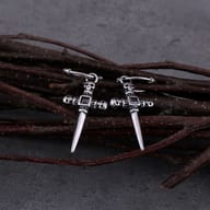 Gothic skull cross drop earrings held in hand to display size and detailed metalwork