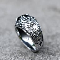 Side profile of the 316L stainless steel ring, highlighting the deep, antique finish of the band's elaborate carvings and the robust construction.