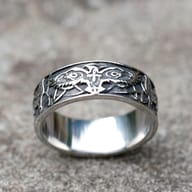 The vintage Viking eagle amulet ring shown on a man's finger, showcasing its fit and appearance