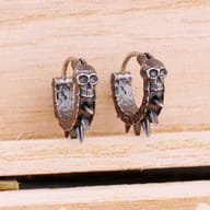 Side profile of men's oxidized skull and spike earring showing hinged clasp