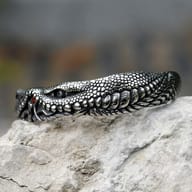 Side profile of the durable stainless steel cuff bracelet on a stone surface.