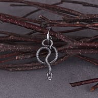 Angled shot showing the dimension and antique finish of the stainless steel serpent earrings