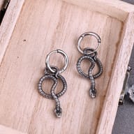 Twisted snake dangle earrings highlighting the smooth hinged hoop clasp mechanism