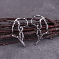 Pair of gothic kraken tentacle stainless steel earrings arranged side by side