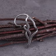 Overhead shot of the pair of gothic octopus tentacle dangle earrings on a stone surface