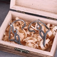 Close-up of the suction cup details and dark oxidized finish on the octopus tentacle earrings