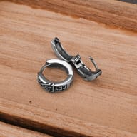 Side angle view of hinged clasp on Viking symbol stainless steel hoop earrings