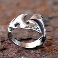 Angled close-up of the right section of the open flame ring, showing the intricate details and reflective surface.