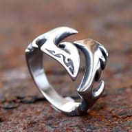 Angled close-up of the left section of the open flame ring, emphasizing its sculpted metallic texture.