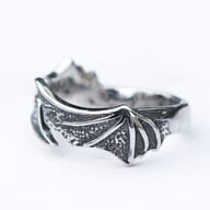 Close-up of the sharp, pointed end of the 316L stainless steel dragon wing ring.
