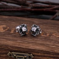 Side view of stainless steel skull stud earring highlighting post and backing