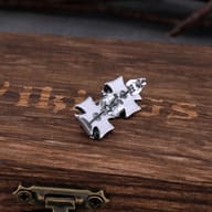Front view of men stainless steel skull cross stud earring showing engraved details