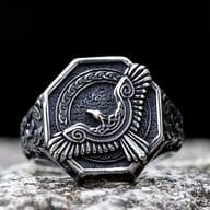Close-up detail of the flying eagle's head and upper wing on the Norse ring.
