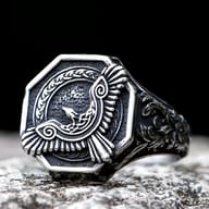 Octagonal antique finish stainless steel ring with a flying eagle and Celtic knotwork design on the face, framed by a braided pattern, and carved scrollwork on the sides.