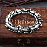 Viking dragon scale stainless steel bracelet resting on a wooden display box