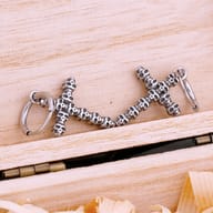 Side profile of gothic cross drop earring showcasing the hinged hoop clasp mechanism
