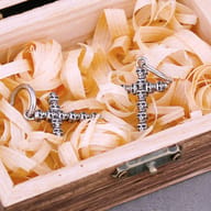 Single skull cross drop earring showing oxidized antique finish on stainless steel