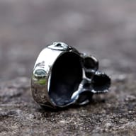 Side view of the skull ring, emphasizing the lower jaw and the textural quality of the 316L stainless steel.