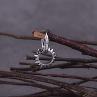 Front view of the silver-toned gothic spiked hoop earrings on display