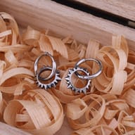 Side angle highlighting the clasp and smooth hoop of the spiked punk earring